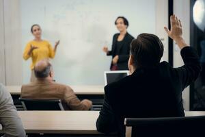 Businesswoman giving presentation to a group of people in a conference room photo