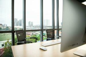 Office workplace with computer on wooden table and city view photo