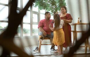 On a new morning, a plus-size family is pleasantly staring out the window. photo