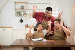 un talla extra familia con un padre vistiendo un protésico pierna, es felizmente ayudando un niño con su deberes y teniendo divertido juntos en el comida habitación de el casa antes de Cocinando juntos foto