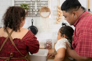 A plus-size family with a father wearing a prosthetic leg, They happily make breakfast together in the in the kitchen room of the house photo