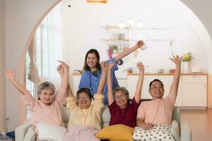 Group of Asian senior and caregiver having fun in the nursing home. photo