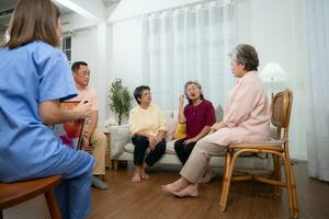 Group of elderly and Asian senior man having a conversation with nurse in the retirement home photo