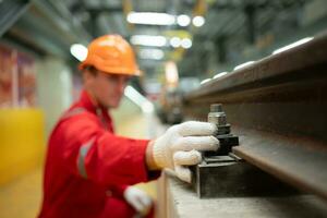 After the electric train is parked in the electric train repair shop, an electric train technician with tools inspect the railway and electric trains in accordance with the inspection round photo