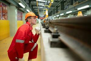 After the electric train is parked in the electric train repair shop, an electric train technician with tools inspect the railway and electric trains in accordance with the inspection round photo