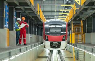 After the electric train is parked in the electric train repair shop, Electric train engineer and technician with tools inspect the railway and electric trains in accordance with the inspection round photo