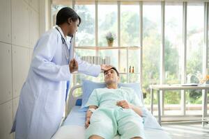 Doctor talking something with patient while lying-in on the bed in the hospital photo