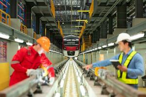 After the electric train is parked in the electric train repair shop, Electric train engineer and technician with tools inspect the railway and electric trains in accordance with the inspection round photo