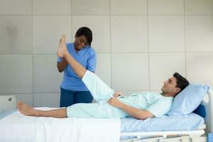 Physiotherapist doing leg massage to patient in the medical office photo