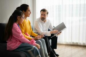 Psychotherapist working with child patient and mother in office, Concept of psychotherapy photo