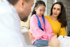 Psychotherapist working with child patient and mother in office, Concept of psychotherapy photo