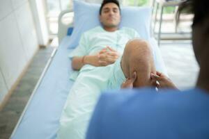 Physiotherapist doing leg massage to patient in the medical office photo