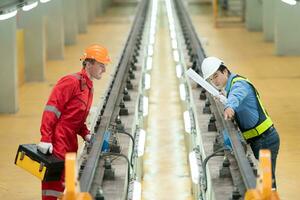 After the electric train is parked in the electric train repair shop, Electric train engineer and technician with tools inspect the railway and electric trains in accordance with the inspection round photo