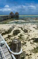 Melia Zanzibar pier on low tide. Blue sky photo