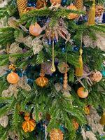 Decorated Christmas tree with orange, pink and golden toys photo