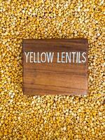 Yellow lentils top view with a nameplate in the middle photo