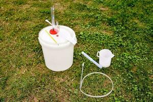 a bucket with a hoses and equipment photo