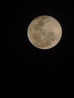 Full moon in the night sky, closeup photo with selective focus