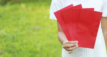 Girl hold red envelope photo