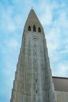 Cathedral of Hallgrimur in Iceland standing majestic as religion tower with holy cross, nordic architectural sacred landmark. Huge Hallgrimskirkja church in icelandic capital, lutheran faith. photo