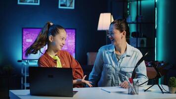 Mom and her child filming video for newly opened family channel. Gen Z media star and parent presenting themselves to audiences, informing them of topics they wish to explore in future clips