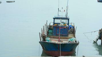 The peaceful sea view with the fishing boat sailing on it in the cloudy day photo