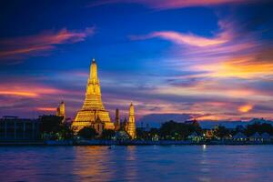 Wat Arun by Chao Phraya River in Bangkok, thailand at night photo