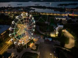 Beautiful sunset over the city with a lighted Ferris wheel. photo