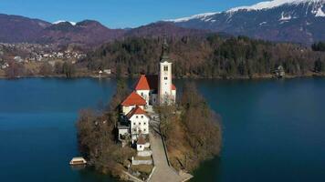 desangrado lago, marijinega vnebovzetja Iglesia y blejski grad en soleado día. Julian Alpes. Eslovenia. aéreo vista. orbital video