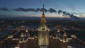 Moscow State University and Illuminated Moscow Skyline at Winter Evening. Russia. Aerial View. Drone is Flying Forward and Approaching. Establishing Shot video