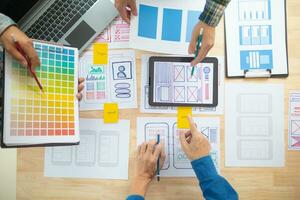 The designer team is designing the uxui system to make the uxui system work well on new phones and support system updates. Website development concept UI UX front end designer photo