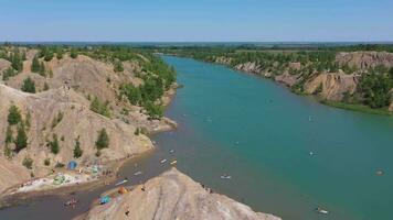 Romantsevskiye Mountains on a Sunny Summer Day. Konduki, Tula Region, Russia. People Sup Surfing and Swimming. Aerial View. Drone Flies Forward, Tilt Up. Reveal Shot video