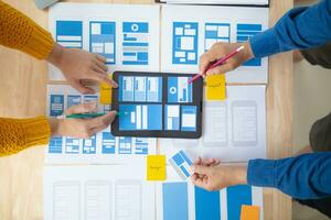 The designer team is designing the uxui system to make the uxui system work well on new phones and support system updates. Website development concept UI UX front end designer photo