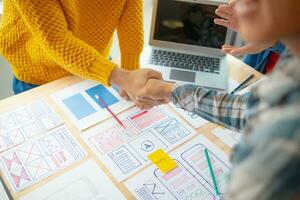 The designer team is designing the uxui system to make the uxui system work well on new phones and support system updates. Website development concept UI UX front end designer photo