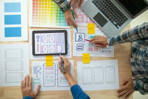 The designer team is designing the uxui system to make the uxui system work well on new phones and support system updates. Website development concept UI UX front end designer photo