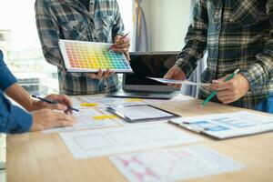 The designer team is designing the uxui system to make the uxui system work well on new phones and support system updates. Website development concept UI UX front end designer photo