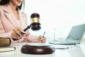 judge's gavel in law office is placed on table to symbolize judge deciding lawsuit. gavel wood on wooden table of lawyers in legal advice office as symbol of fair judgment in cases. photo