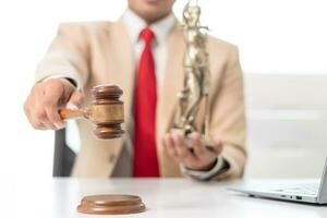 gavel wood Brass scales and a statue of Themis Lady Justice are placed on the tables of the lawyers in the legal counsel's office as a symbol of justice. Concept building trust with symbols of justice photo