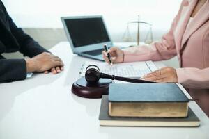 judge's gavel in law office is placed on table to symbolize judge deciding lawsuit. gavel wood on wooden table of lawyers in legal advice office as symbol of fair judgment in cases. photo