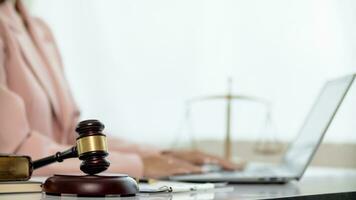 judge's gavel in law office is placed on table to symbolize judge deciding lawsuit. gavel wood on wooden table of lawyers in legal advice office as symbol of fair judgment in cases. photo