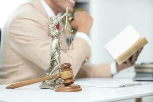 judge's gavel in law office is placed on table to symbolize judge deciding lawsuit. gavel wood on wooden table of lawyers in legal advice office as symbol of fair judgment in cases. photo