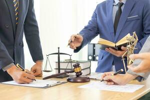 judge's gavel in law office is placed on table to symbolize judge deciding lawsuit. gavel wood on wooden table of lawyers in legal advice office as symbol of fair judgment in cases. photo