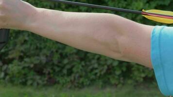 Woman is pulling on bowstring of the bow and shooting. Archery. video