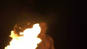 Muscular Man is throwing fireball with flame. Fire show. Super Slow motion. video