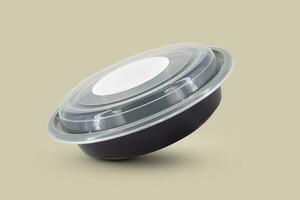 Black plastic food containers with transparent lid and white cardboard label photo