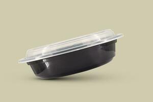 Black plastic food containers with transparent lid and white cardboard label photo