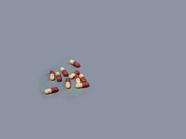 Pills spilling out white and two-colored capsules pills  Medicines and prescription pills flat lay background. medical pills and tablets spilling out of a drug bottle.Copy space for text photo