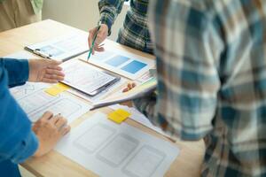 The designer team is designing the uxui system to make the uxui system work well on new phones and support system updates. Website development concept UI UX front end designer photo