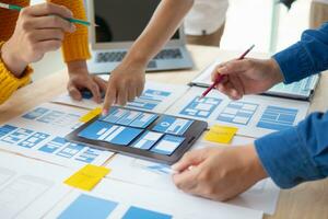 The designer team is designing the uxui system to make the uxui system work well on new phones and support system updates. Website development concept UI UX front end designer photo