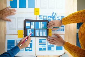 The designer team is designing the uxui system to make the uxui system work well on new phones and support system updates. Website development concept UI UX front end designer photo